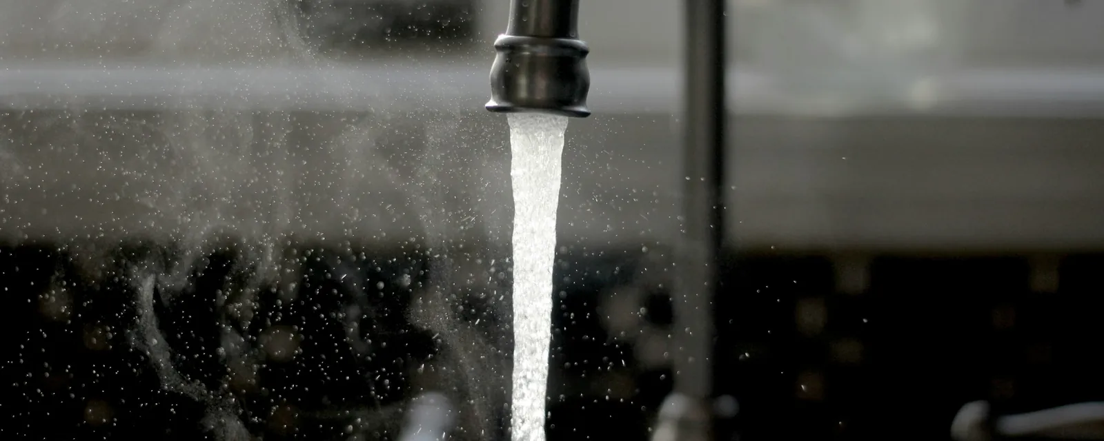Water running from a kitchen faucet into a sink