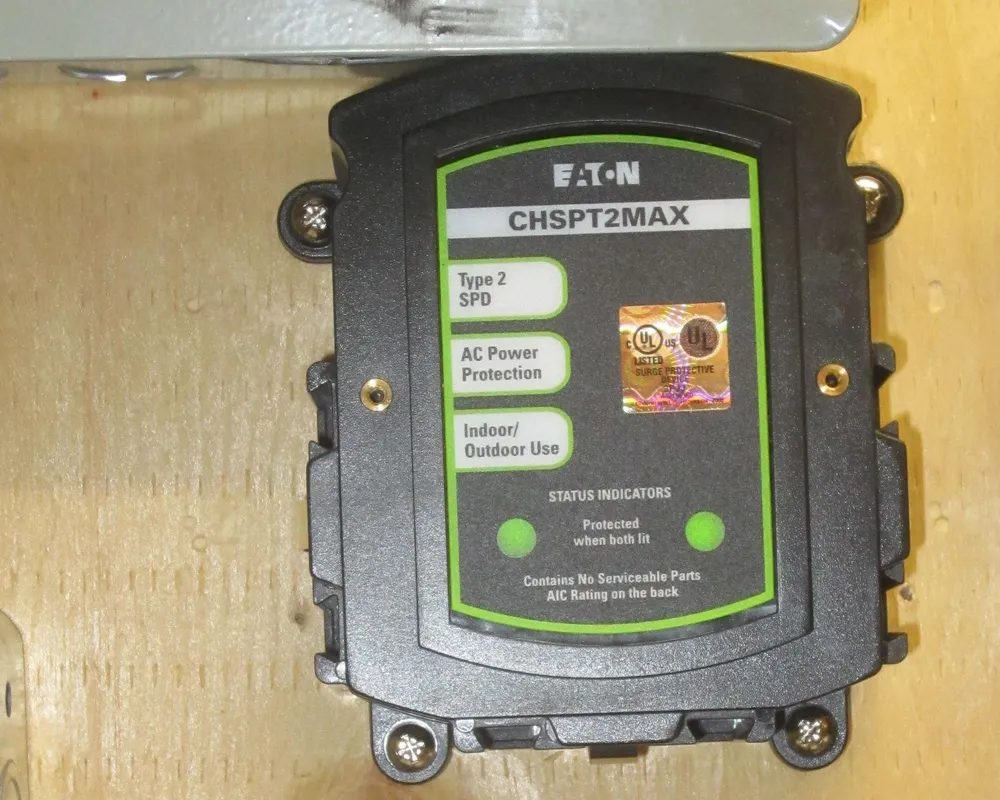 Eaton Type 2 whole-house surge protector mounted below a breaker panel with two green status lights